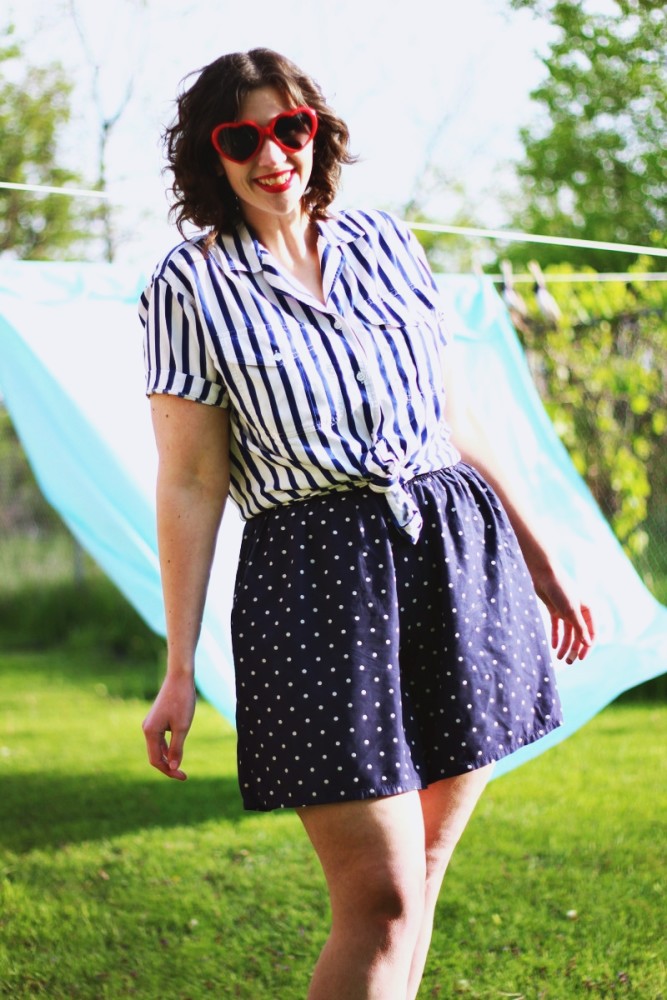 Outfit mixing striped shirt, polka dotted shorts and red heart sunglasses. Sunny outdoor photos with a bed sheet!