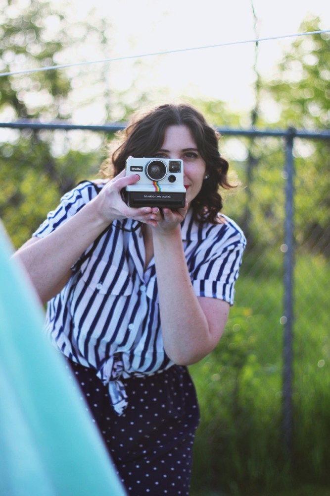 Outfit mixing striped shirt and polka dotted shorts. Sunny outdoor photos with a bed sheet and Polaroid camera!