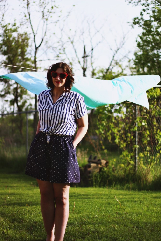 Outfit mixing striped shirt, polka dotted shorts and red heart sunglasses. Sunny outdoor photos with a bed sheet!