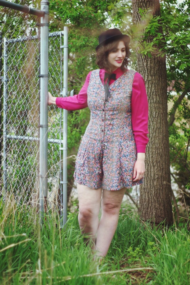 Pink button up under a floral romper and topped off with a black bow tie.