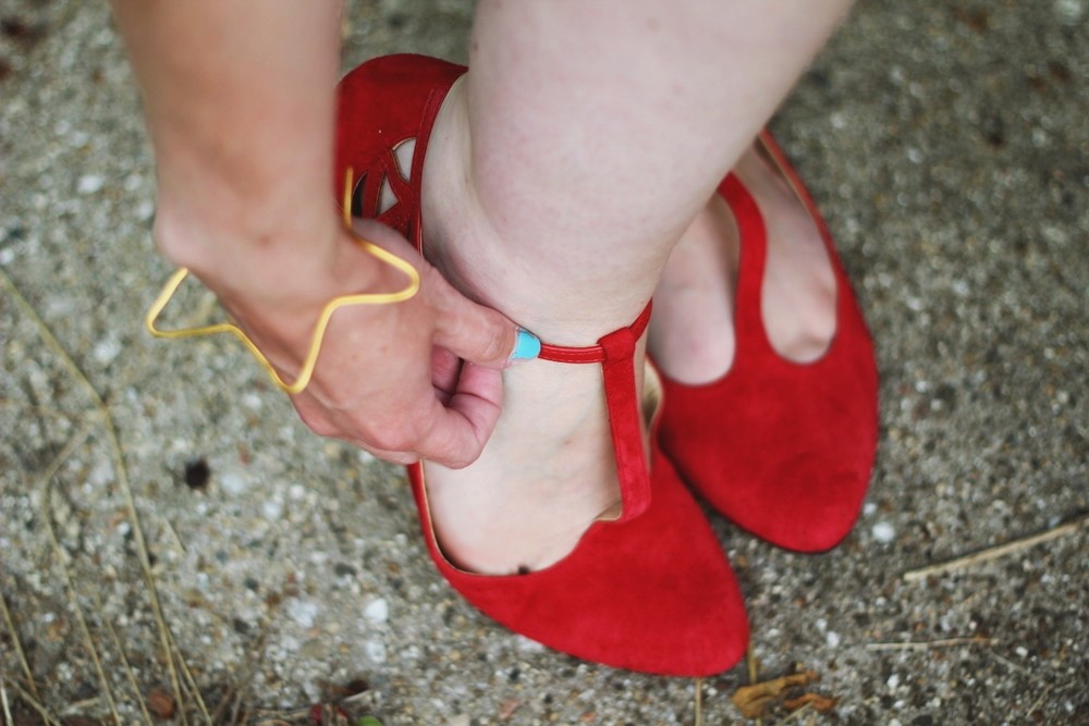Patriotic outfit with a red striped top and blue polka dotted skirt.