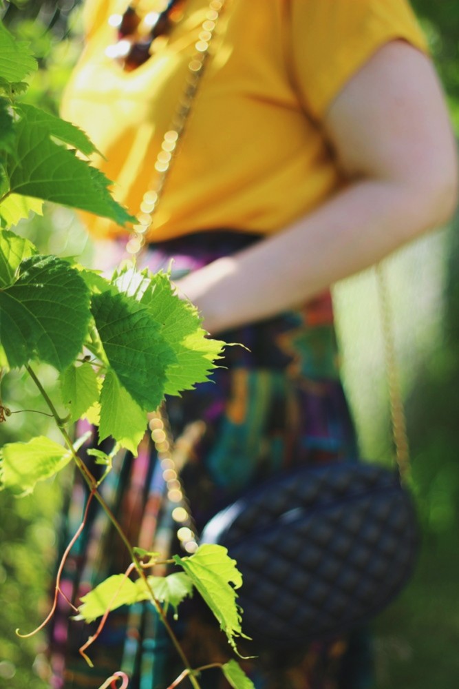 the outfit repeater hannah rupp yellow blouse multi-color skirt thrifted quilted purse beaded necklace