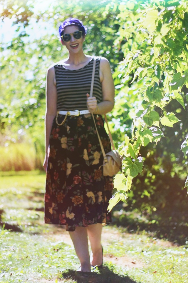 Fall outfit details: Striped tank top, dark floral print skirt, small beige purse, white and gold lion head belt, purple pixie haircut
