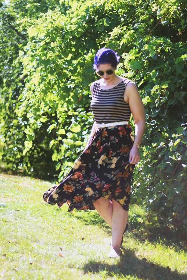 Fall outfit details: Striped tank top, dark floral print skirt, small beige purse, white and gold lion head belt, purple pixie haircut