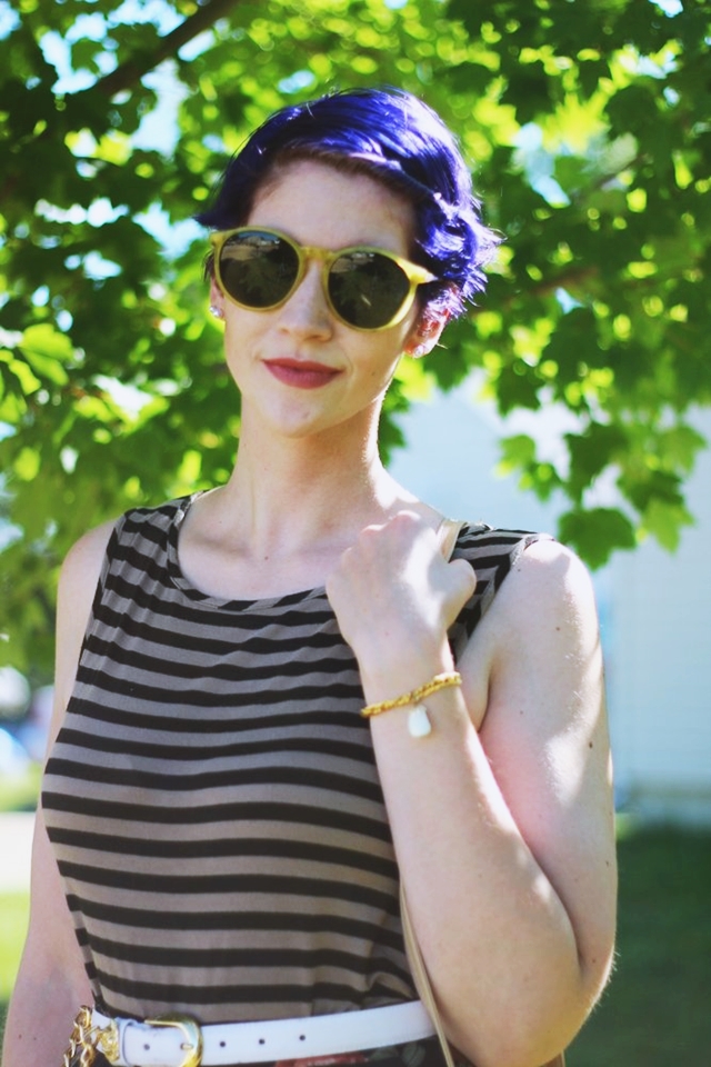 Fall outfit details: Striped tank top, dark floral print skirt, small beige purse, white and gold lion head belt, purple pixie haircut