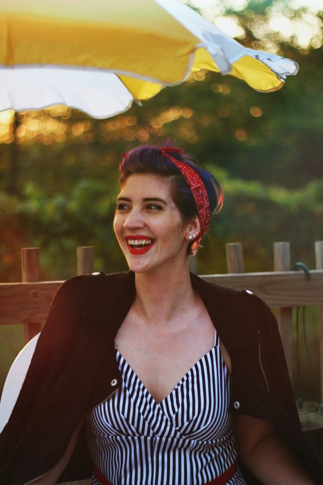 Outfit: Striped retro style dress, black moto jacket, red kitten heels, vintage red belt, red bandana, purple pixie cut