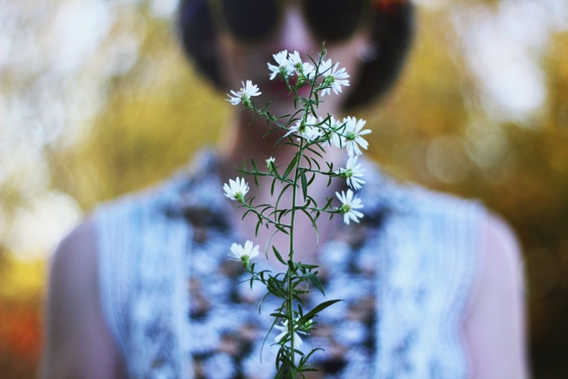 White weeds stand out in front of a 1970s inspired outfit