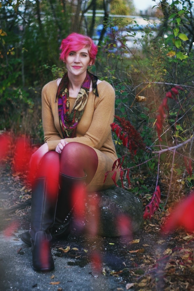 Outfit: camel colored thrifted sweater dress, burgundy maroon tights, dark brown knee high boots, purple multi-colored scarf, curly bright pink pixie cut short hair