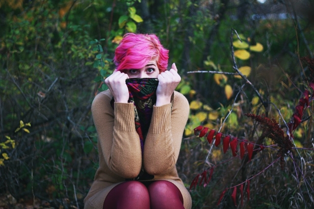 Outfit: camel colored thrifted sweater dress, burgundy maroon tights, dark brown knee high boots, purple multi-colored scarf, curly bright pink pixie cut short hair