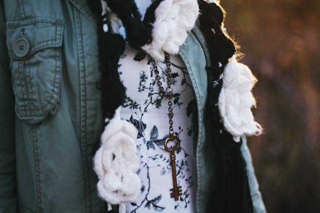 outfit details: key necklace, black and white floral dress, utility jacket, crochet flowered scarf
