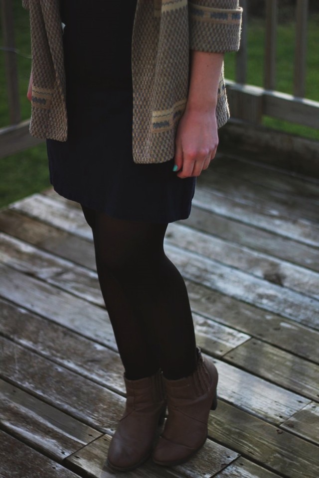 outfit: black high neck early 2000's dress, black tights, camel tan heeled booties, vintage patterned cardigan