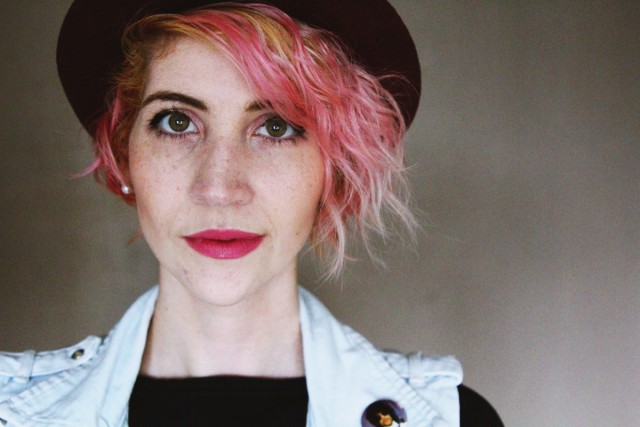 Face: pale skin, mauve lipstick, hazel eyes, processed bleach pink and platinum hair, purple H&M bowler hat