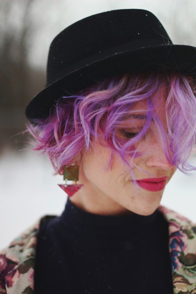 Pretty In Pink inspired volcanic ensemble: Black mockneck bodycon dress, black pork pie hat, 80s-era statement earrings, ultra violet mermaid hair