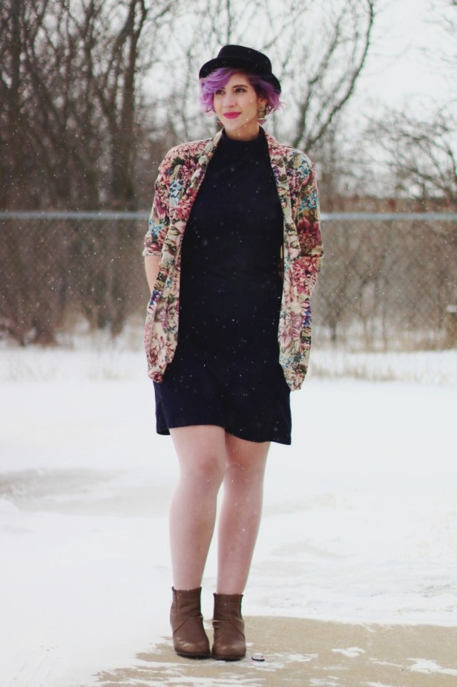 Pretty In Pink inspired volcanic ensemble: Black mockneck bodycon dress, vintage floral blazer, black pork pie hat, 80s-era statement earrings, beige booties