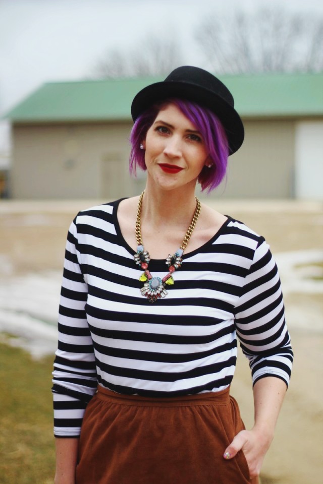 Outfit: striped top, brown suede skirt, statement necklace, red lip, black pork pie hat, purple hair