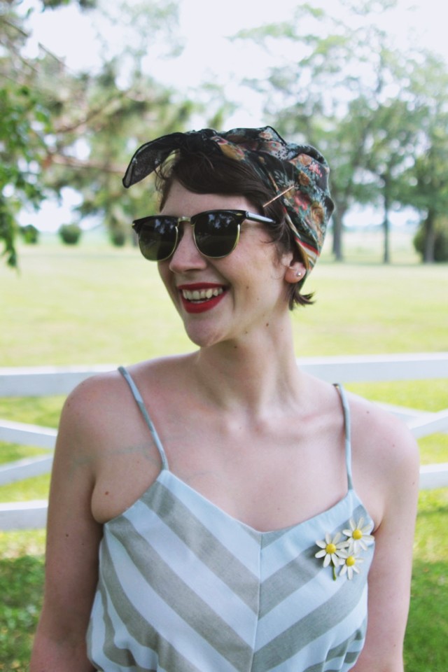 Wearing a headscarf in place of a hat.