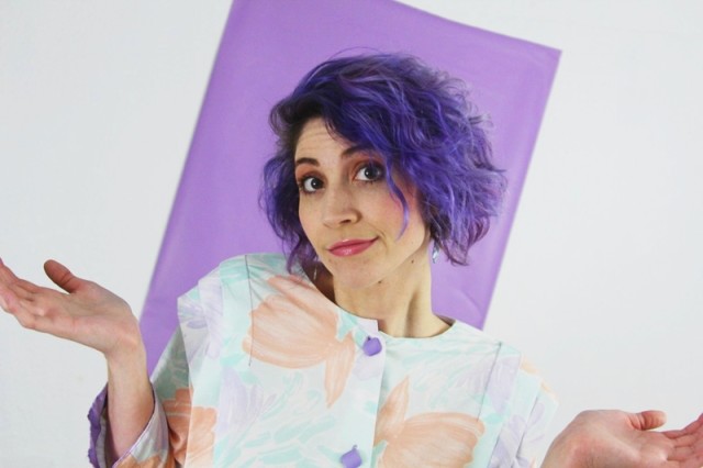 1980's fashion outfit: pastel tunic, gray leggings, violet curly hair, acid washed belt