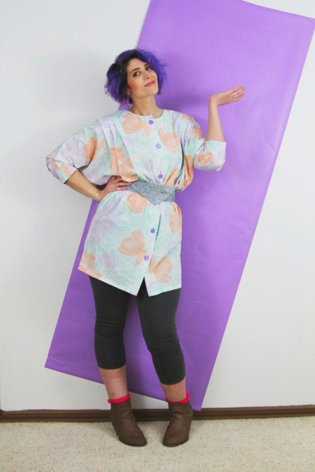 1980's fashion outfit: pastel tunic, gray leggings, violet curly hair, acid washed belt