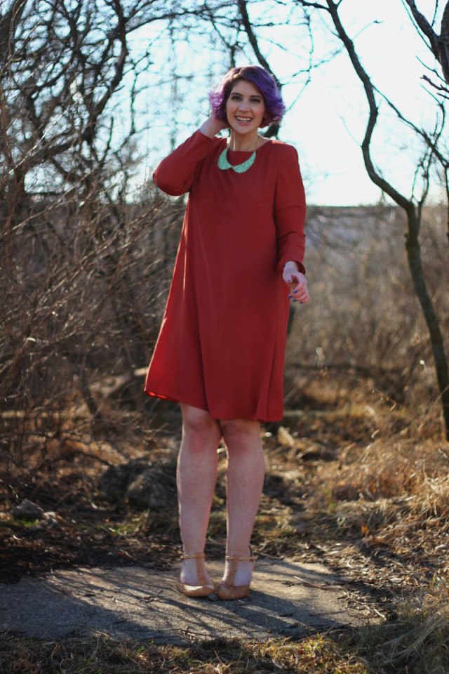 1960's fashion inspired by the movie Rosemary's Baby: burnt orange dress, blue peter pan collar necklace, curly purple hair, mod makeup, t-strap heels