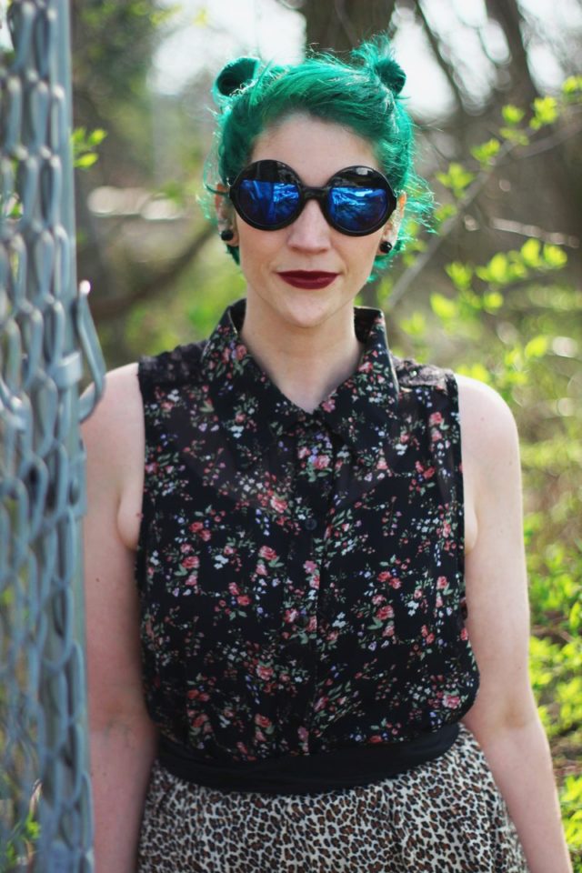 Anti-spring outfit: floral sleeveless button up, round sunglasses, green hair