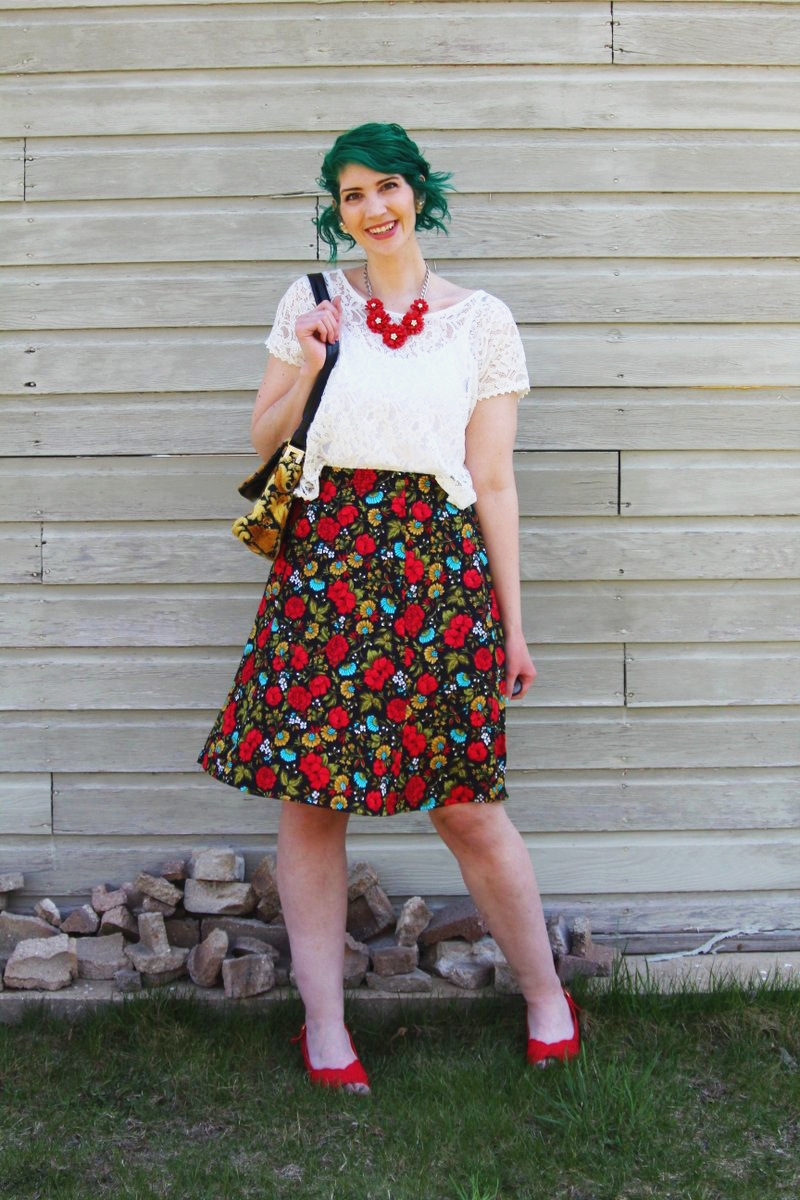 Spring style outfit: Target white lace crop top, vintage thrifted red floral skirt, thrift yellow carpet bag, red flower necklace, Punky Colours green hair, vintage red kitten heels pattern mixing