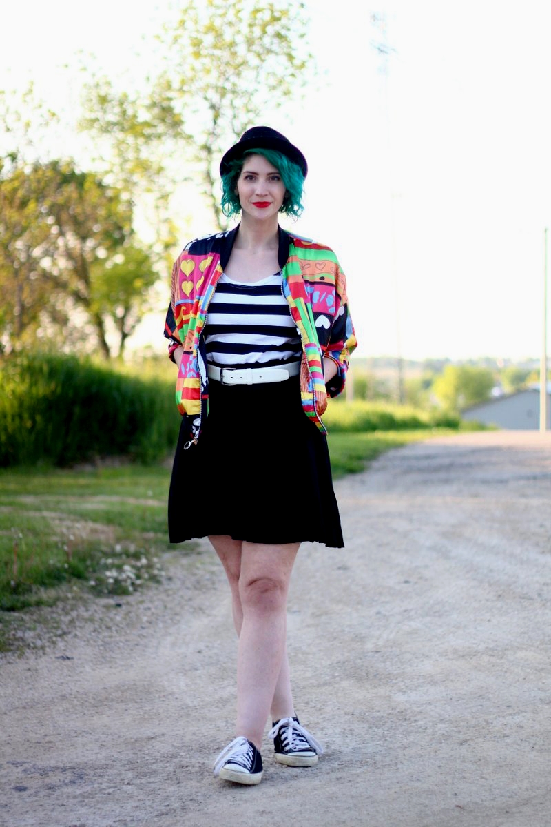A Colorful Bomber Jacket + Tips For Wearing Statement Clothes | theoutfitrepeater.com Outfit: brightly patterned jacket, striped top, black skirt, thick white belt, green hair, pork pie hat, red lipstick, black sneakers