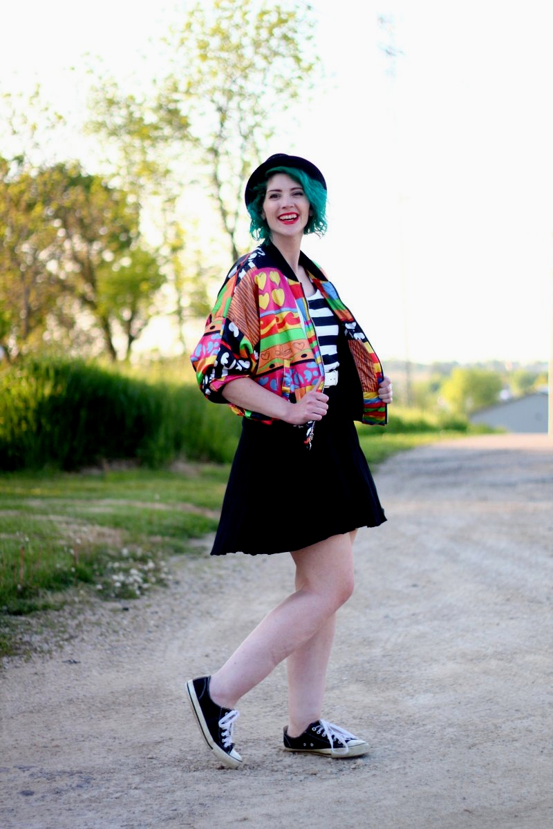 A Colorful Bomber Jacket + Tips For Wearing Statement Clothes | theoutfitrepeater.com Outfit: brightly patterned jacket, striped top, black skirt, thick white belt, green hair, pork pie hat, red lipstick, black sneakers