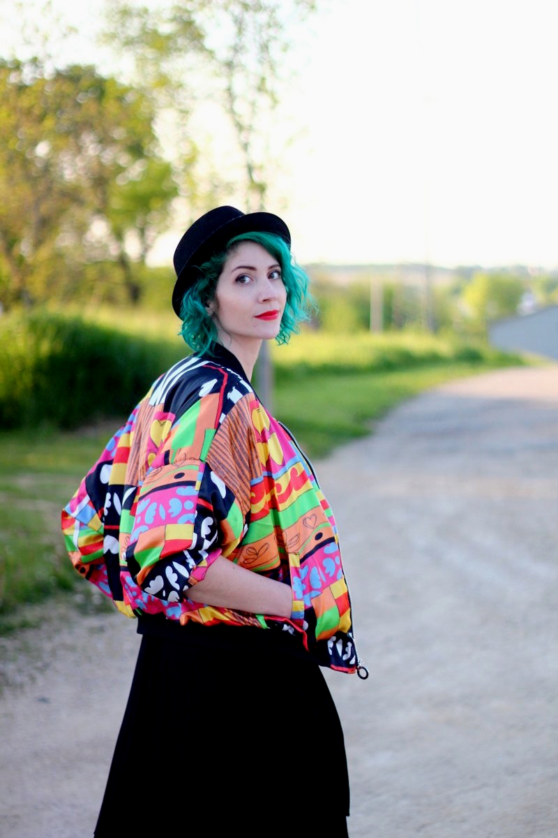 A Colorful Bomber Jacket + Tips For Wearing Statement Clothes | theoutfitrepeater.com Outfit: brightly patterned jacket, striped top, black skirt, thick white belt, green hair, pork pie hat, red lipstick