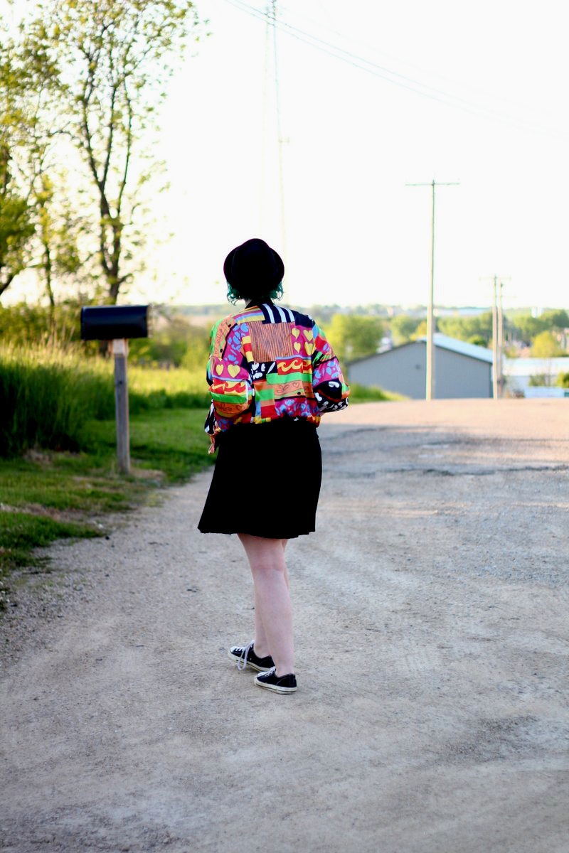 A Colorful Bomber Jacket + Tips For Wearing Statement Clothes | theoutfitrepeater.com Outfit: brightly patterned jacket, striped top, black skirt, thick white belt, green hair, pork pie hat, black sneakers