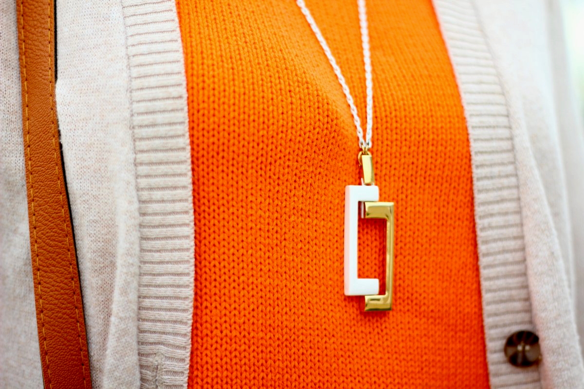 Vintage orange top, beige cardigan, retro gold and white necklace