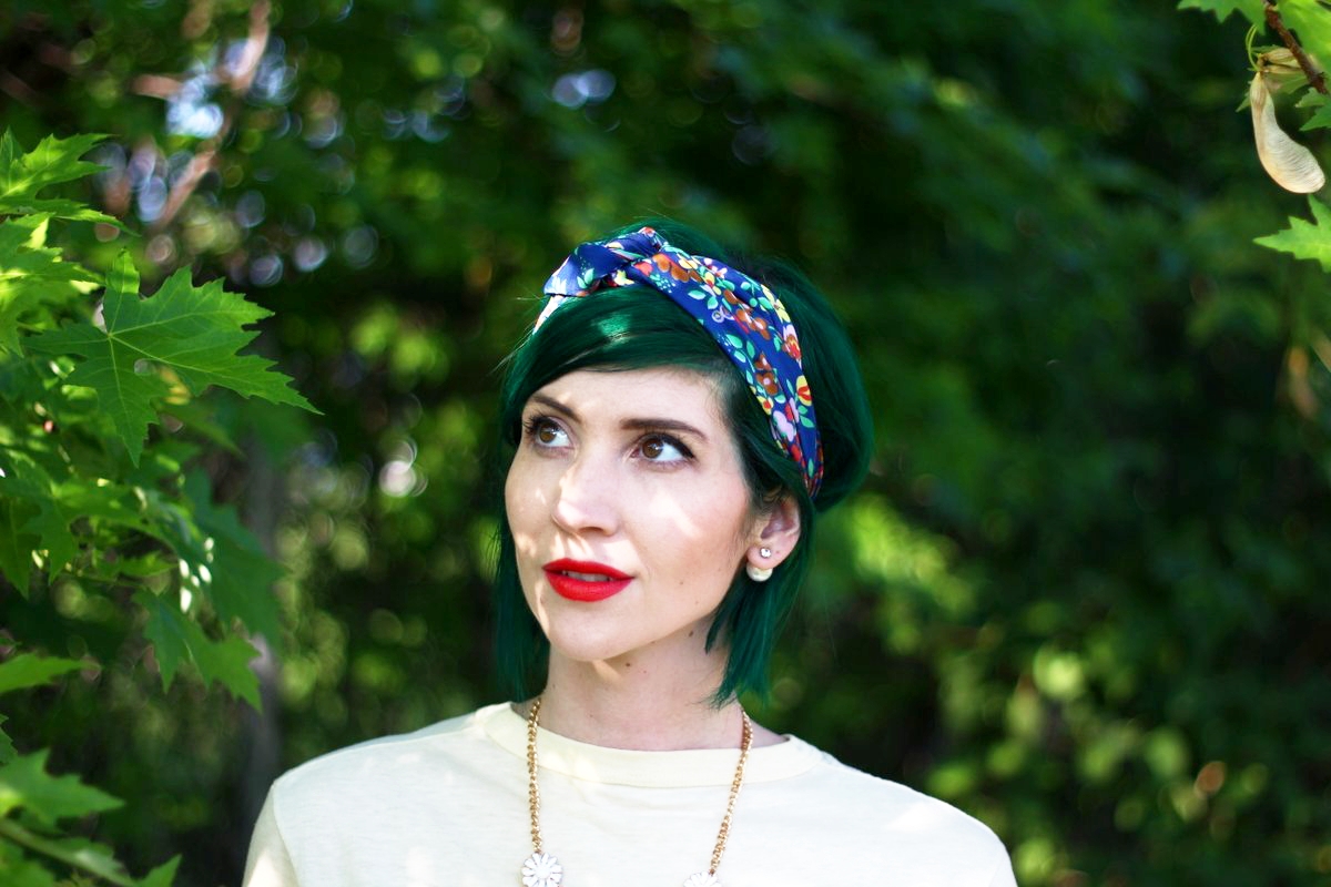Outfit: primary colors, yellow t-shirt, floral headscarf, flower bib necklace, red lipstick