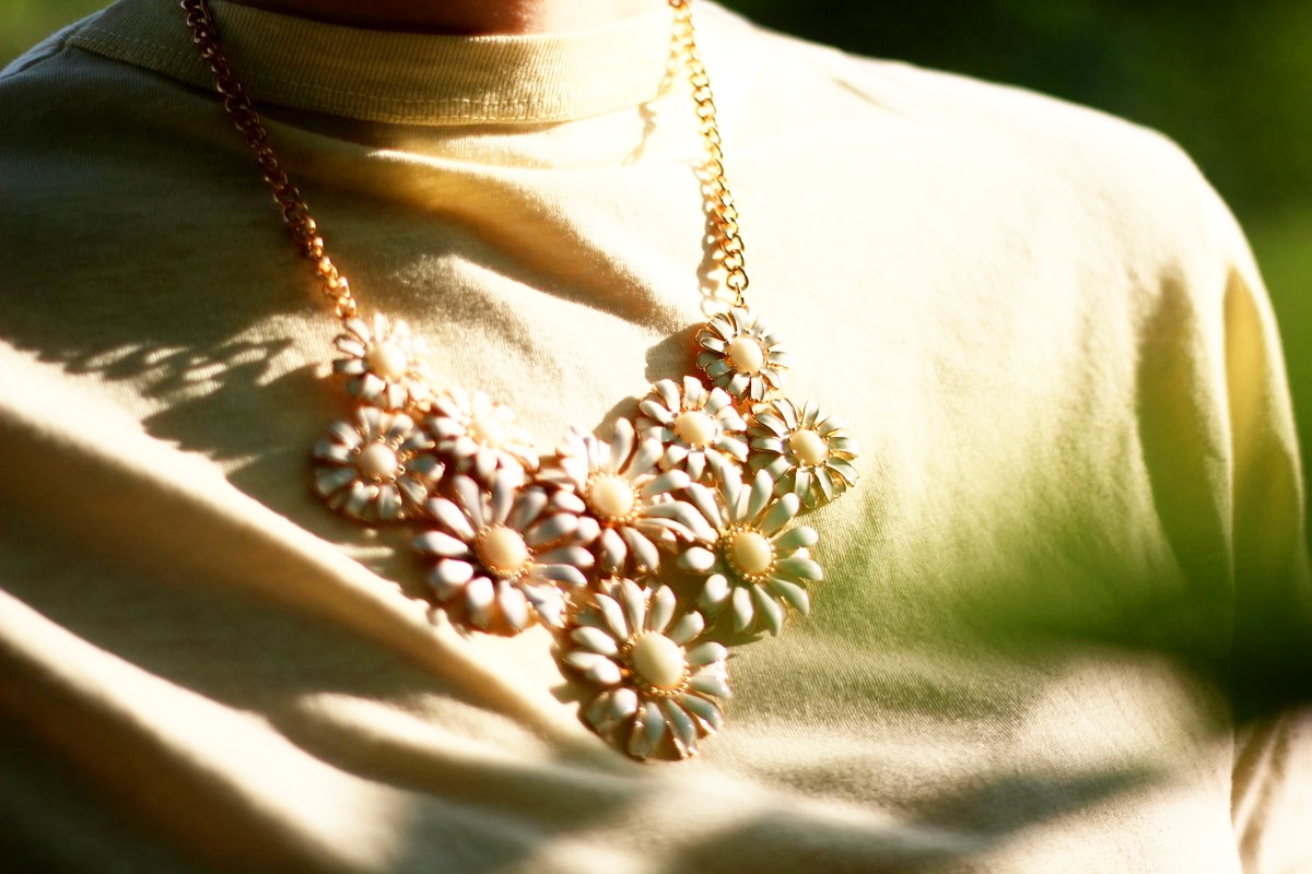 Outfit details: yellow t-shirt and flower bib necklace