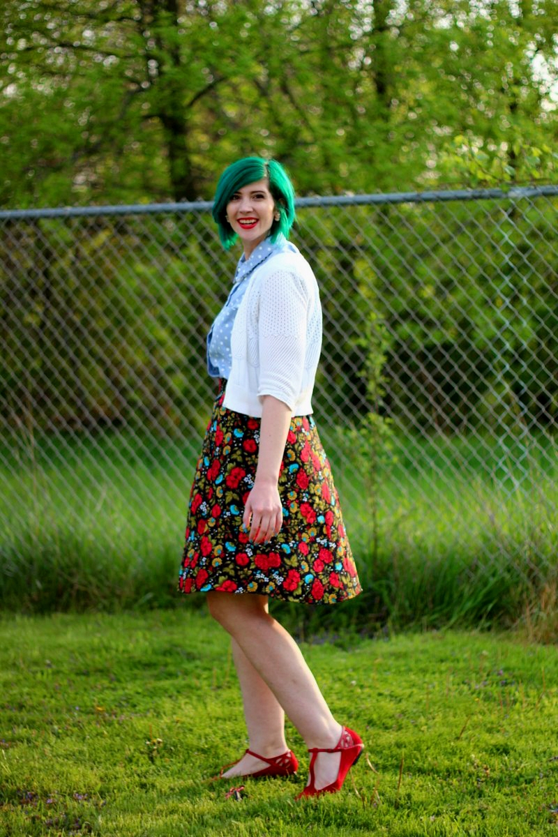 Outfit: polka dot chambray top, black floral skirt, green hair, white cardigan, vintage beaded necklace, red lips, red t-strap flat shoes