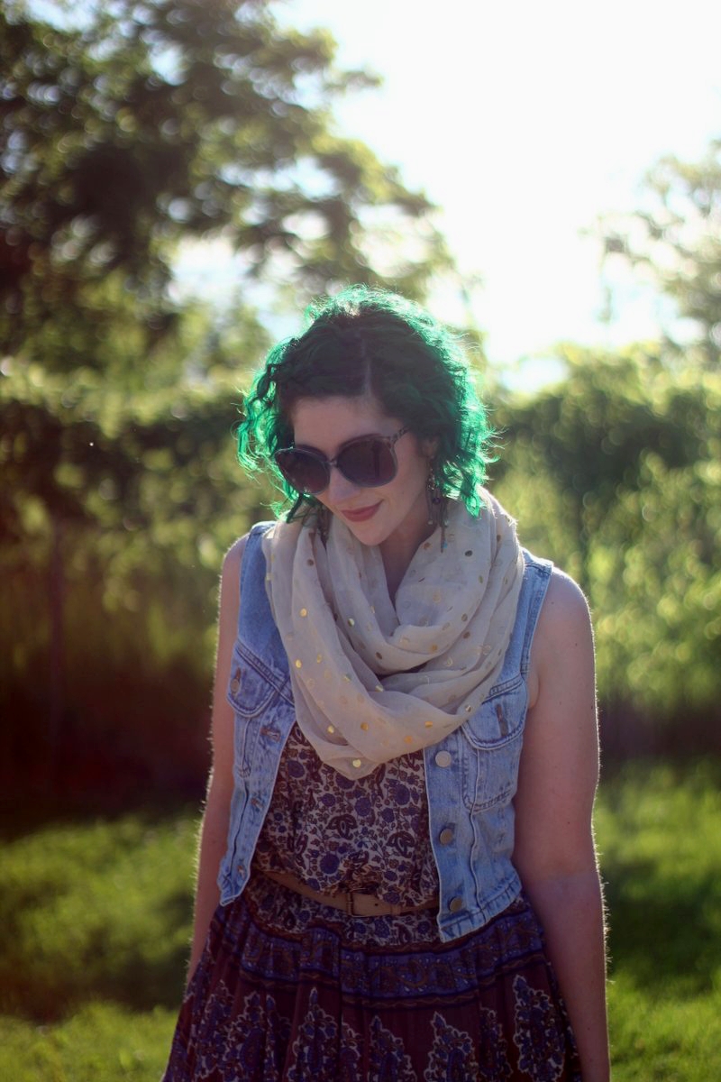 Outfit: patterned summer dress, light wash denim vest, gold polka dot scarf, beige belt, sunglasses, green hair