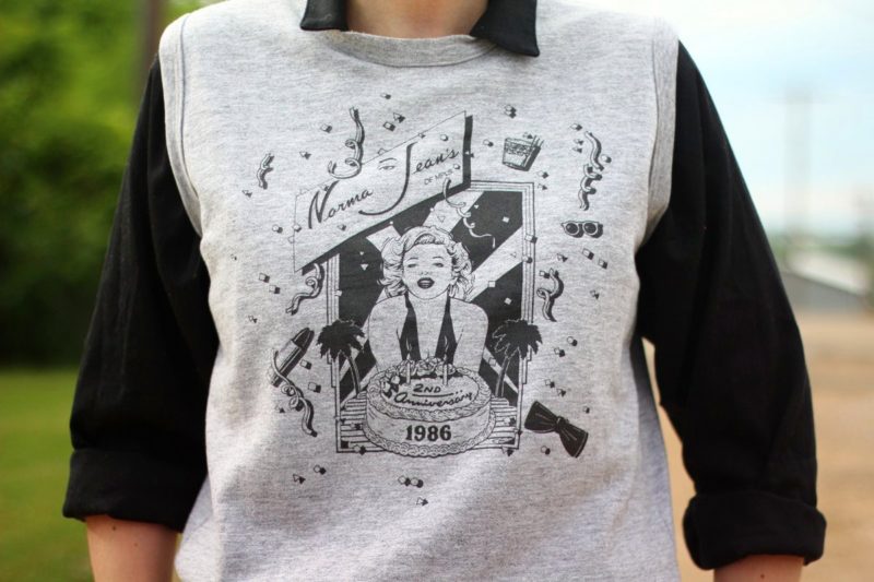 Ferris Bueller's Day Off movie inspired outfit: thrifted black jumpsuit, gray 1986 sleeveless sweatshirt