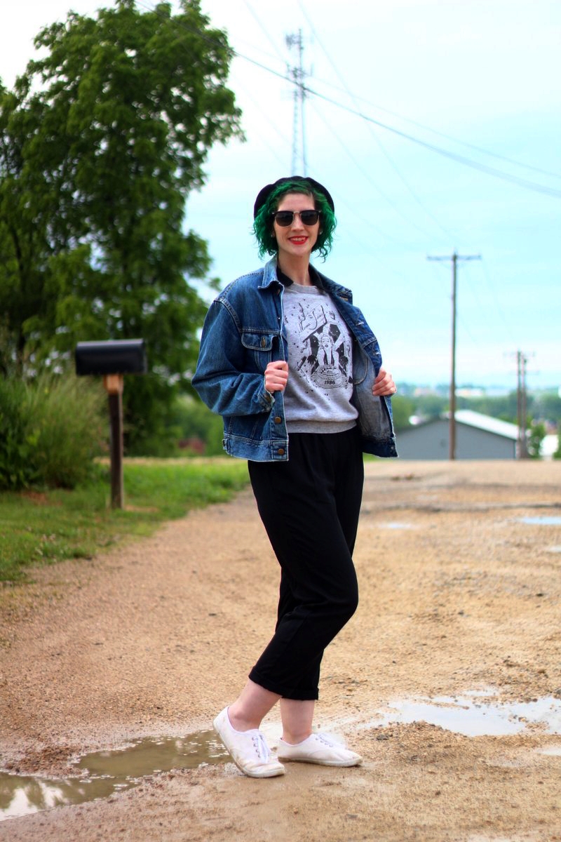 Ferris Bueller's Day Off movie inspired outfit: thrifted black jumpsuit, gray 1986 sleeveless sweatshirt, vintage denim jacket, black beret, black sunglasses, red lipstick, green hair, white sneakers