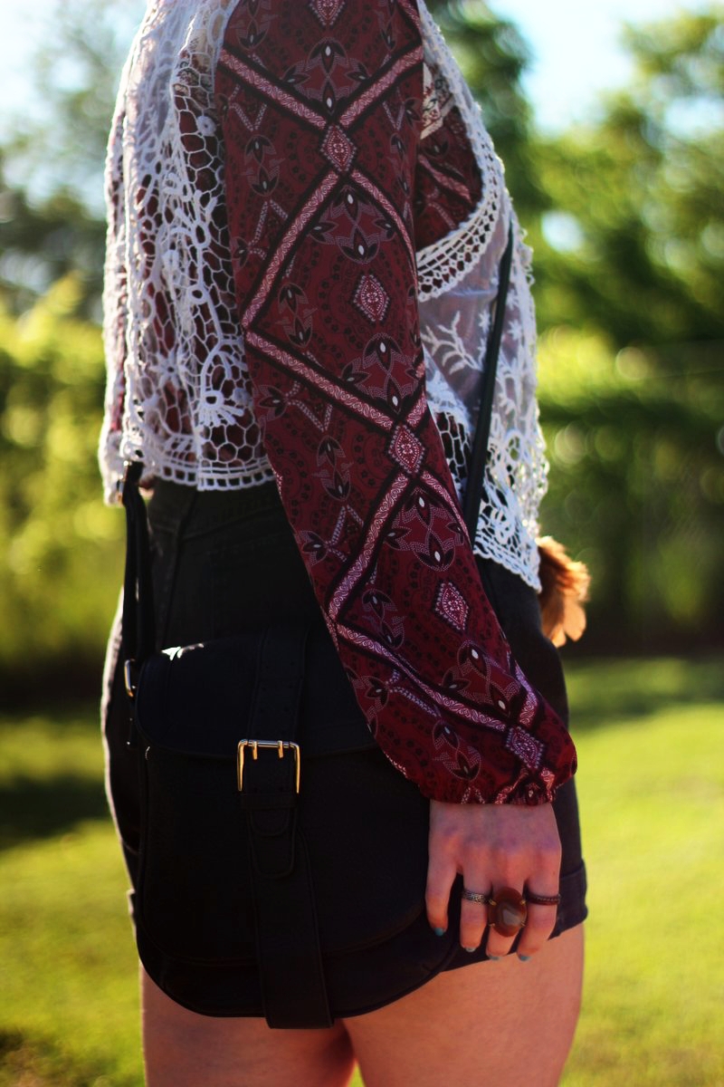 boho style red peasant blouse, black jean shorts, white lace vest, purse