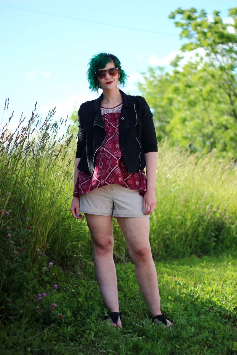 1 Top, 2 Music Festival Outfits | theoutfitrepeater.com white female standing in a sunny, grassy field. wearing a boho style red peasant blouse, beige striped shorts, and sandals.