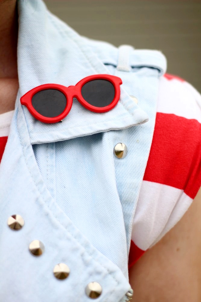 Outfit details: red and white striped tunic, denim studded vest, vintage red sunglasses pin