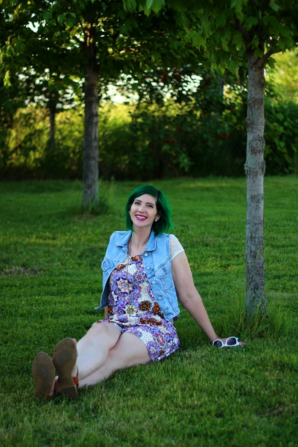 Outfit: purple boho romper overalls, white lace tee, light wash denim vest, green hair, purple lipstick, white sunglasses, Target glitter sandals