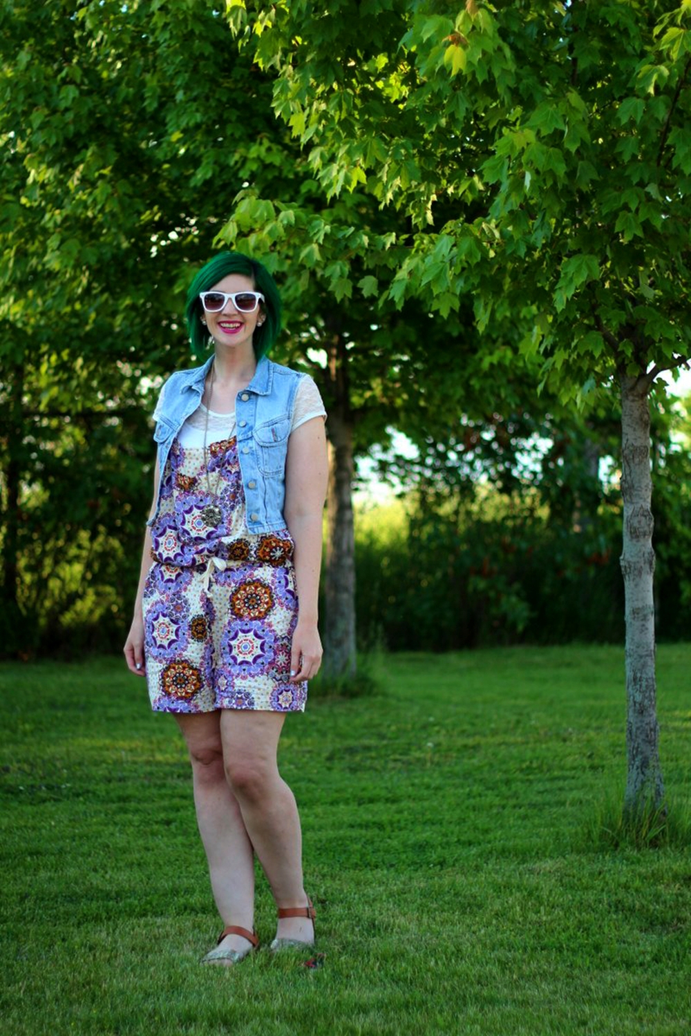 Outfit: purple boho romper overalls, white lace tee, light wash denim vest, green hair, purple lipstick, white sunglasses, Target glitter sandals