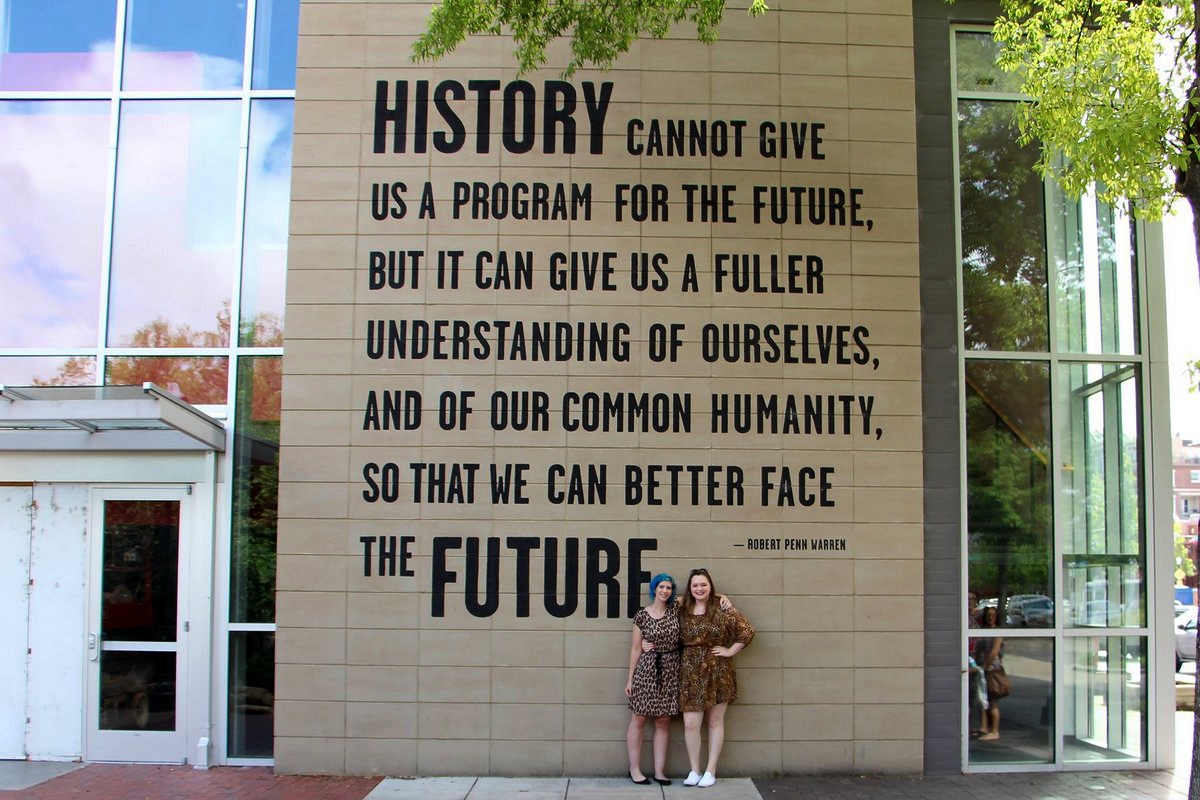 What I Wore On My Summer Vacation | theoutfitrepeater.com Outfits: leopard print dresses in front of quote wall at Chattanooga Tennessee Aquariam