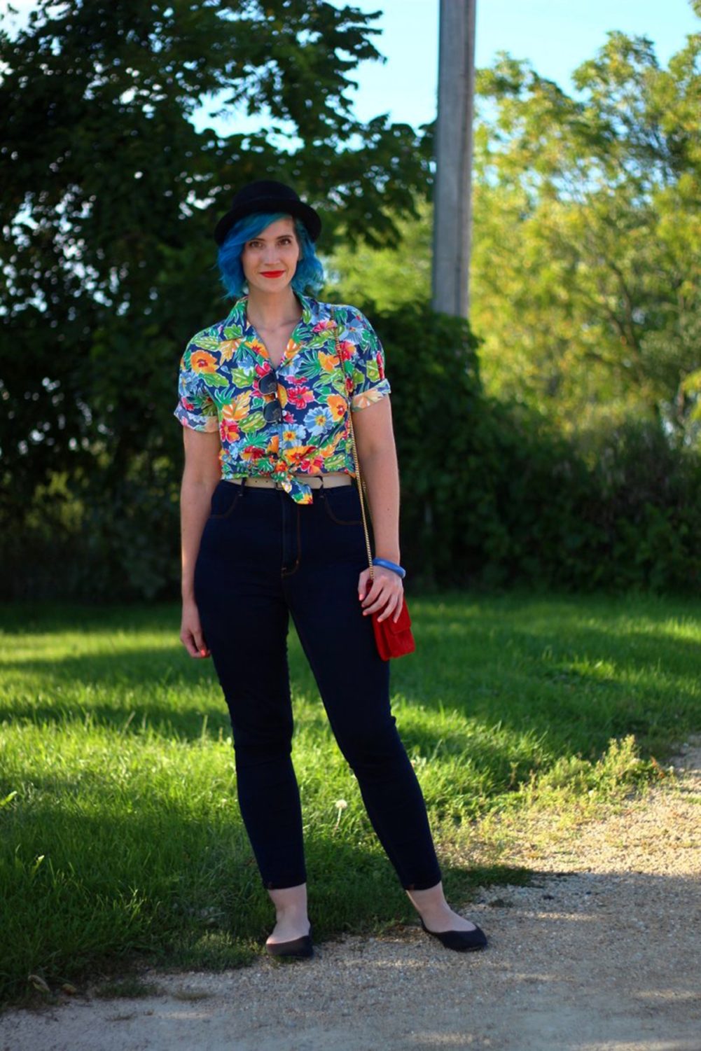 Outfit: Hawaiian print shirt, high waisted dark wash jeans, small red purse, NYX red lipstick, blue hair, black pork pie hat, black flats