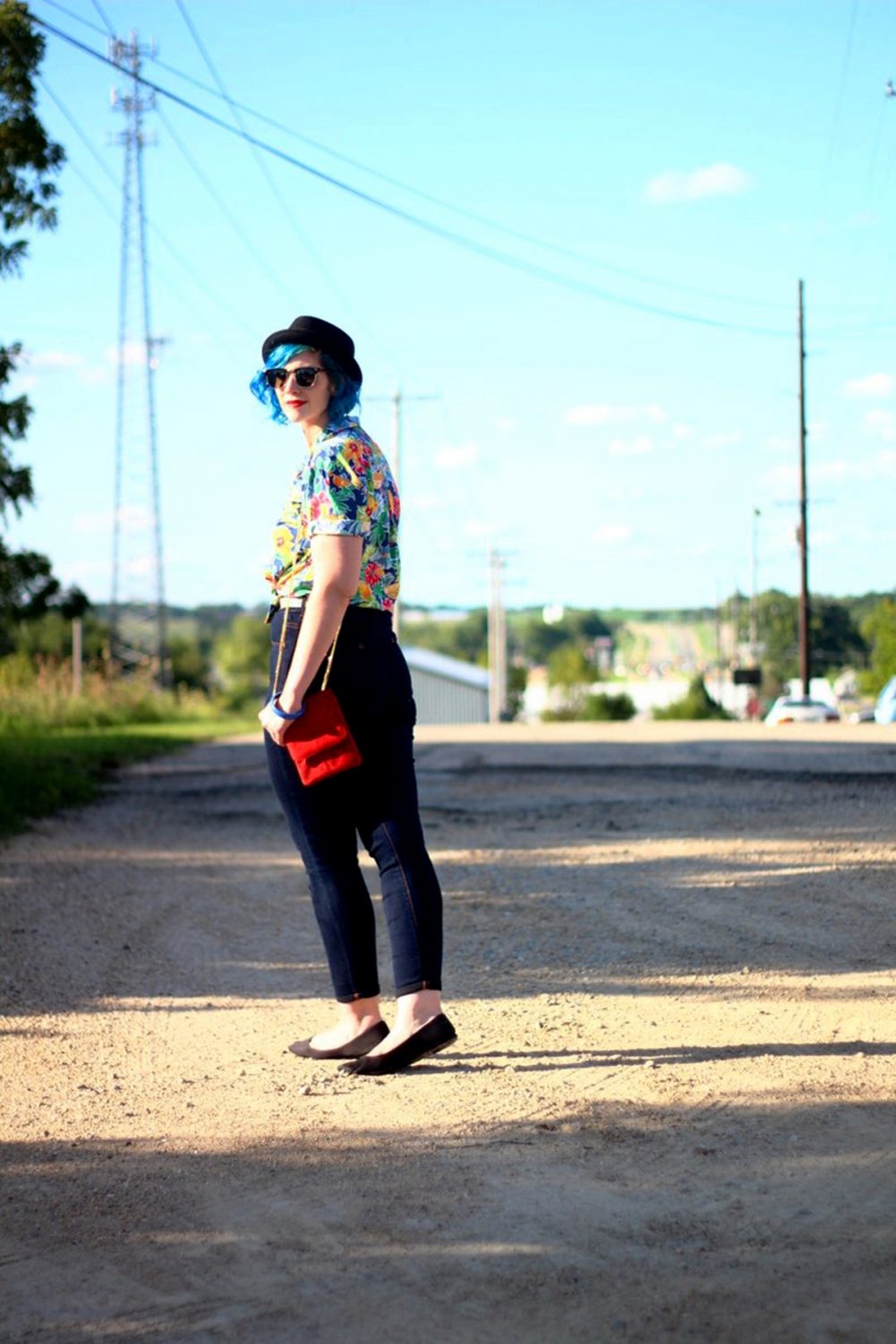 Outfit: Hawaiian print shirt, high waisted dark wash jeans, small red purse, NYX red lipstick, blue hair, black pork pie hat, black flats