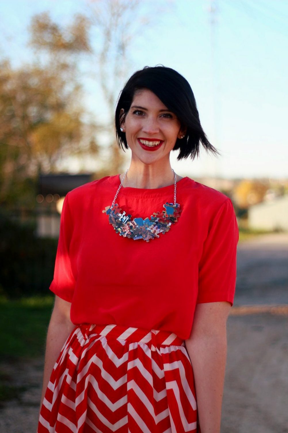 Outfit: Vintage red top, DIY puzzle piece necklace, red lipstick, thrifted orange chevron skirt