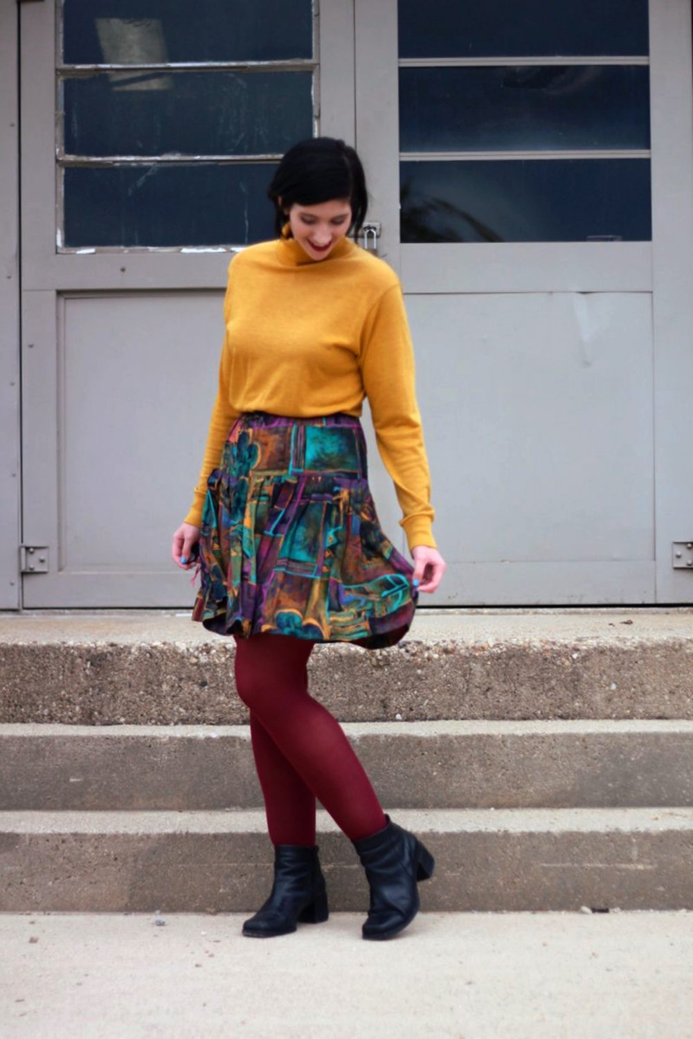Outfit: mustard yellow turtleneck, multi colored skirt, maroon tights, black booties