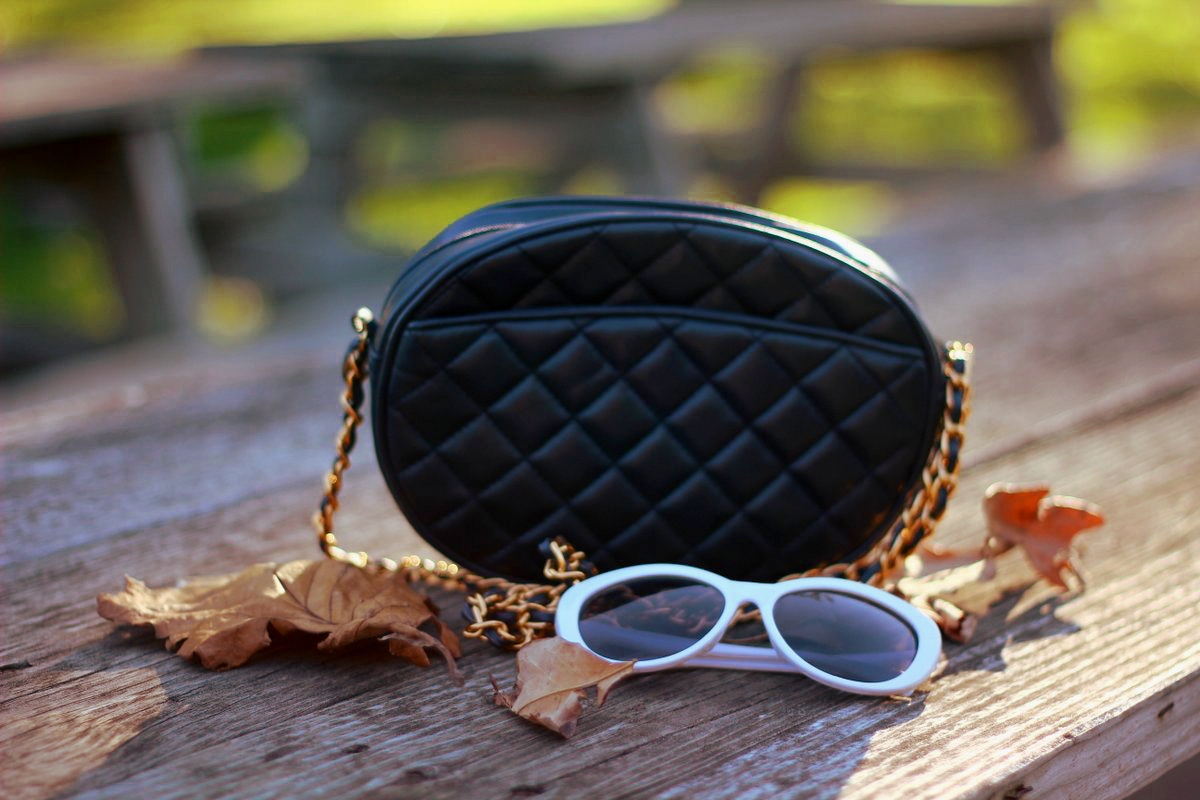 Outfit details: quilted navy blue purse, white over sized cat eye sunglasses