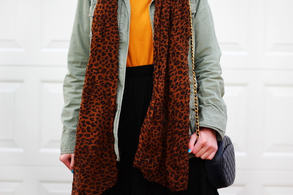 Outfit: mustard yellow turtleneck, olive green utility jacket, leopard print scarf, black skater skirt,navy blue quilted purse