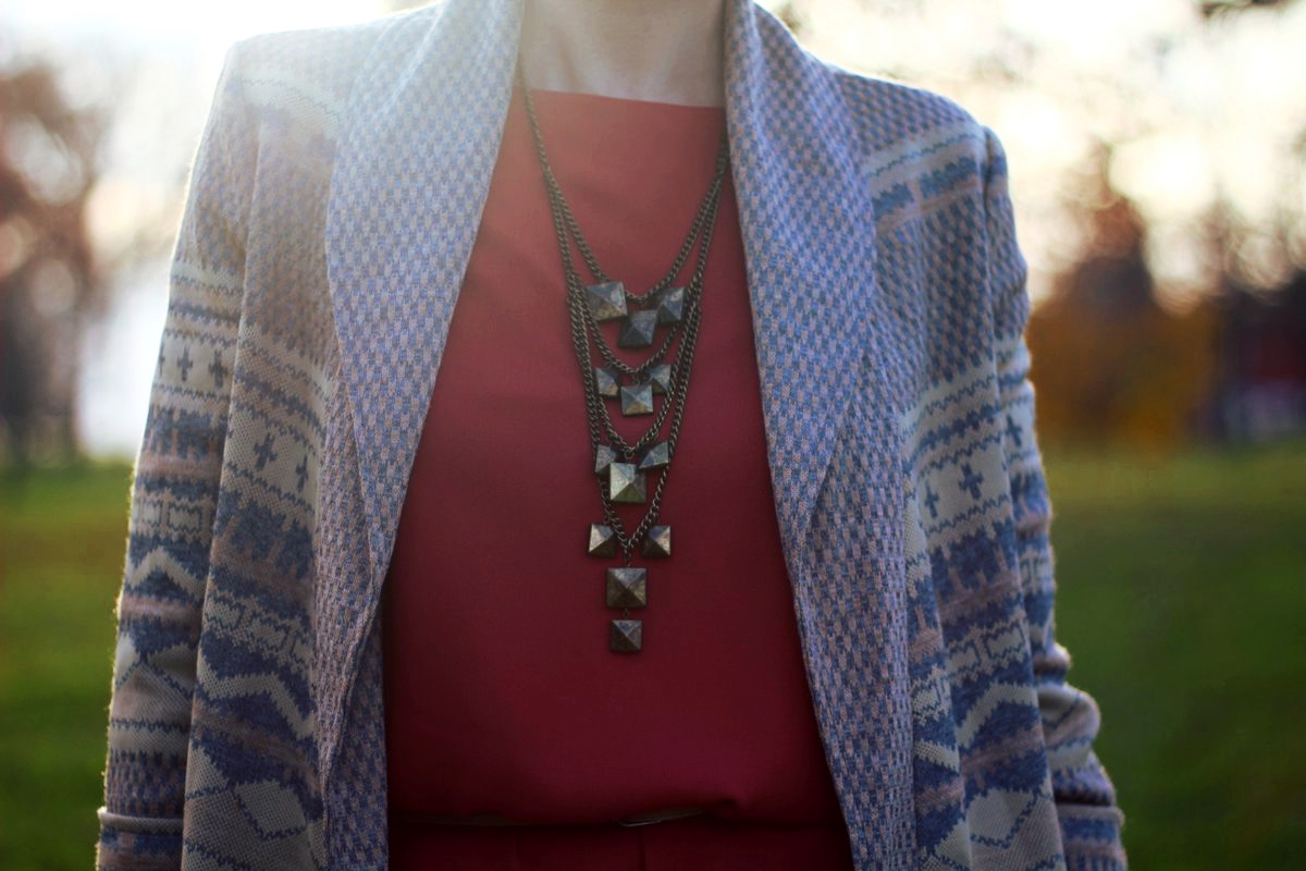 Outfit details: Orange dress, bronze necklace, patterned cardigan