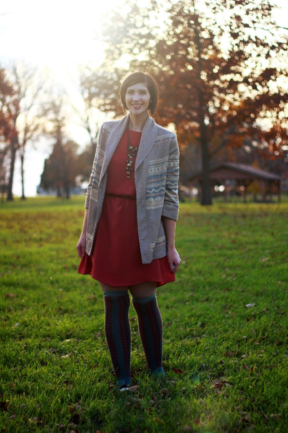 Outfit: Orange dress, beige belt, bronze necklace, patterned cardigan, otk colorful socks, brown flats 